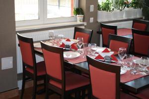 a dining room with a table and chairs with wine glasses at Hotel Viva in Ploieşti
