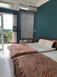 Postel nebo postele na pokoji v ubytování An Ngọc Linh Hotel