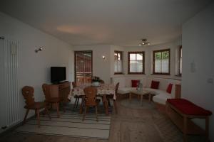 a living room with a table and a couch at Villetta ai Pini Deluxe in Canazei