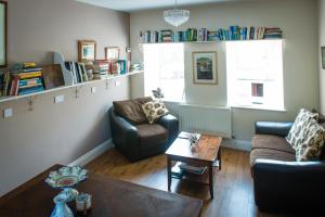 a living room with two chairs and a table at Ballinwillin House in Mitchelstown