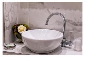 a white sink with a faucet in a bathroom at Ludovica's Apartment in Termoli