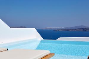a swimming pool with a view of the ocean at Phos The Boutique in Akrotiri