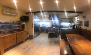 a large room with a kitchen with a counter and a counter at Beltzenia Txoko in Urrugne