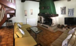 a living room with a couch and a fireplace at Maison Beltzenia in Urrugne