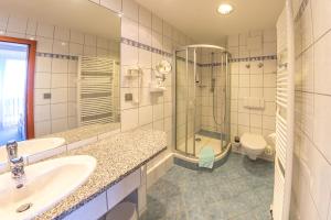 a bathroom with a sink and a shower and a toilet at WAGNERS Sporthotel Oberhof in Oberhof