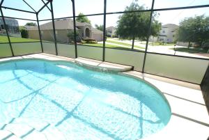 an empty swimming pool in a building with windows at VILLA ORLANDO CHARM in Davenport