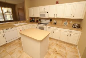a kitchen with white cabinets and a counter top at VILLA ORLANDO CHARM in Davenport