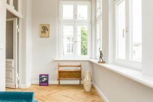 a living room with a blue chair and a window at OSTKÜSTE - Nadler Hof Design Apartments in Ahlbeck