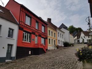 a cobblestone street in a town with colorful houses at L'Art Du Temps le Gîte in Montreuil-sur-Mer