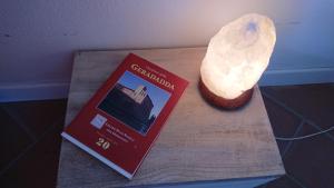 a book sitting on a table next to a bowl of food at B&B IL Loto BIKE FRIENDLY in Vailate