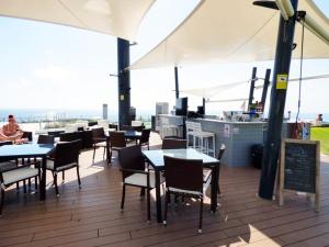 a restaurant with tables and chairs on a roof at INFINITY VIEW Arenales in Arenales del Sol