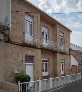 un edificio con balcones en un lateral en Rakel, en Muros
