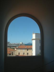 an arched window with a view of a building at Hotel Villa d'Elsa in Juan-les-Pins