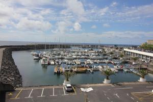 a harbor filled with lots of boats in the water at Vinha da Areia Beach Hotel in Vila Franca do Campo