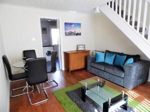 a living room with a couch and a table at The Upper Craigour Royal infirmary House in Edinburgh