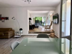 a living room with a couch and a table at Clos Des Plages Maison De Vacances in La Ciotat