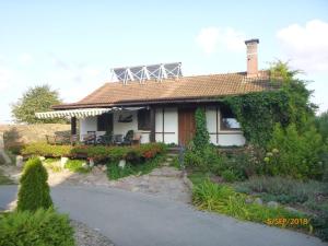 a small house with a pathway leading to it at Klimbergowice in Sztum