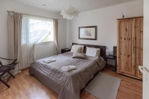 a bedroom with a bed with two towels on it at Terra Ultima in Rovaniemi