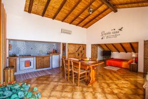 a kitchen and living room with a table and a bed at Mansarda sopra il mare in San Marco dʼAlunzio