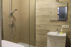 a bathroom with a shower and a toilet and a sink at Apartment - Heart of Odessa in Odesa +33 photos