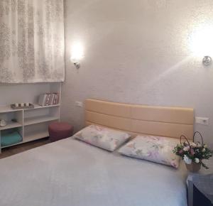 a bedroom with a bed with two pillows at Apartment - Heart of Odessa in Odesa