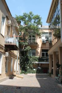 an apartment building with a tree in front of it at Apartment - Heart of Odessa in Odesa