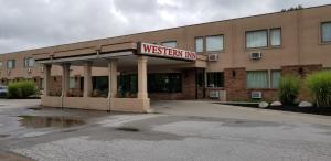 a westen inn sign in front of a building at Western Inn in Council Bluffs +2 photos