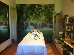 a bedroom with a wall mural of a waterfall at Cala Rosa Club Hotel in Stintino