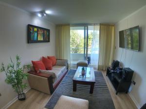 a living room with a couch and a coffee table at Departamento reñaca bosque in Viña del Mar
