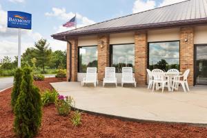 a patio with white chairs outside of a restaurant at Baymont by Wyndham Warrenton in Warrenton