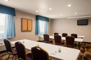 a conference room with tables and chairs and a tv at Baymont by Wyndham Warrenton in Warrenton +44 photos
