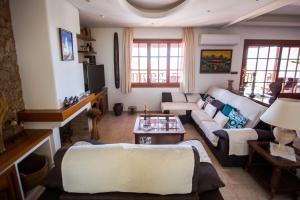 a living room with a couch and a table at Villa Ca na Vinya in Cala Tarida