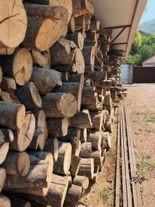 a pile of logs on the side of a building at Forest Hotel Palmira in Mnogorechye