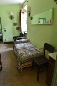 a bedroom with a bed and a mirror on the wall at Il Palazzetto B&B in Viterbo