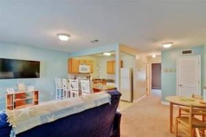 a living room with a couch and a dining room at Beach Comber at Oak Shores in Biloxi