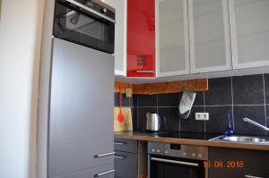 a kitchen with white cabinets and a refrigerator at FW Sonnenschein in Wechterswinkel