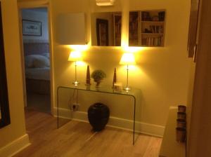 a room with two lamps on a table in a room at The Garden Flat in London