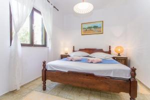 a bedroom with a bed with two stuffed animals on it at Beachside Villa Marko in Milna