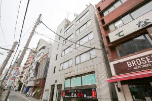 a building on the side of a city street at Station Condominium Otsuka in Tokyo