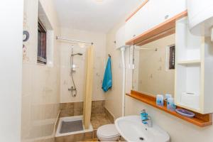 a bathroom with a shower toilet and a sink at Beachside Villa Marko in Milna +65 photos