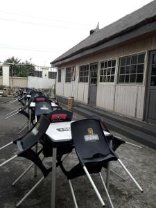 a row of tables and chairs in front of a building at Grand Inn & Suites in Ijebu Ode