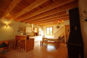 a living room with a table and a kitchen at Lupin in Formiguères