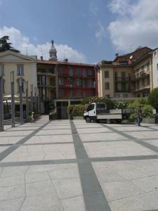 a parking lot with a white truck and buildings at Casa Vacanza Bergamo Centro in Bergamo