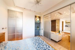 a bedroom with a king sized bed and a bathroom at Brivibas LUX in Riga