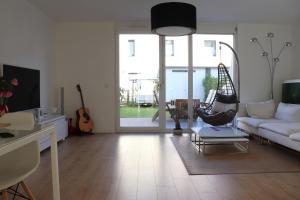 a living room with a white couch and a swing at Privatzimmer an der Messe in Hannover