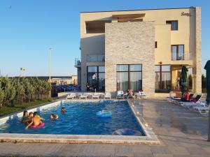 a group of people playing in a swimming pool at Sara in Vama Veche
