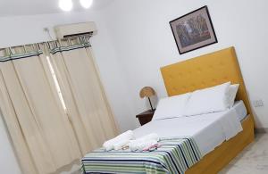 Una cama o camas en una habitación de Pai Pajarito
