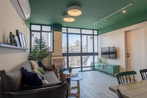 a living room with a couch and a table at Golda Vacation Rentals in Jerusalem