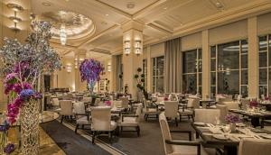 a banquet hall with tables and chairs and flowers at The Peninsula Chicago in Chicago