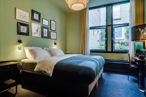 a bedroom with a bed and a window at SeventyFive in Amsterdam